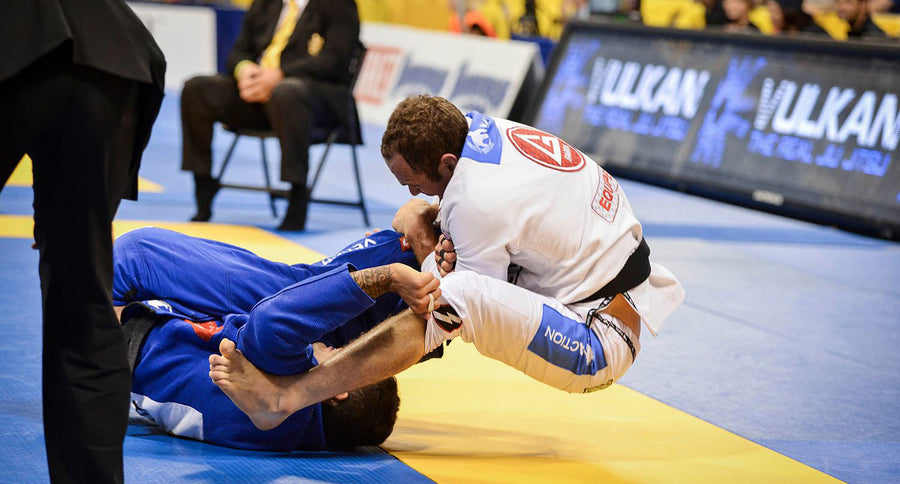 Two BJJ fighters wrestling. One is using the Estima Lock on his opponent.